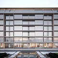 Modern Multi Storey Building Featuring Large Glass Windows Water Pool And Green Plants At Base