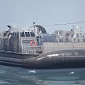 Hovercraft Warship Sailing On Sea With Large Fans And Inflatable Skirt Creating Water Splashes