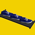Three Pairs of Blue Canvas Shoes Displayed on a Black Shelf