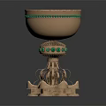 Ornate Golden Cup With Green Gemstone Embellishments And Intricate Pedestal Base