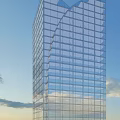 Modern Tall Office Building With Glass Curtain Wall Against Blue Sky Background