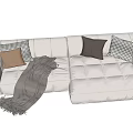 Plush Beige L shaped Sectional Sofa With Brown Checkered Pillows And Throw Blanket