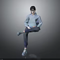 A Man in Blue Hoodie Blue Pants and Blue Shoes Sitting Cross-Legged Against Gray Background