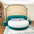 Teal Green Velvet Round Bed With Gold Decorative Headboard And Floral Rug