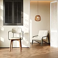 Modern White Accent Chair in Bright Interior with Wooden Floor Window Shutters and Pendant Light
