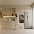 Modern Kitchen With Light Colored Cabinets Appliances And Woman Walking By