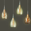 Modern Glass Pendant Lights With Teardrop Shape And Brass Finish On Dark Background