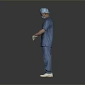 Male Medical Professional In Blue Surgical Scrubs With Cap Mask And Gloves