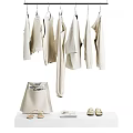 Hanging Beige Clothes With Matching Bag Shoes And Accessories On White Table
