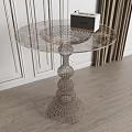 Round Side Table In Modern Interior With Transparent Patterned Top And Metal Wireframe Base