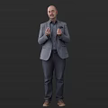 Man Wearing Gray Blazer and Shirt Gesturing with Hands Against Dark Background