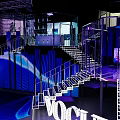 VOGUE Modern Exhibition Space With Illuminated Staircase And Blue Lighting Interior