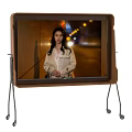 Sleek Modern Television Screen With Metal Stand Displaying Night Scene Person