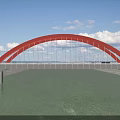 Modern Red Arch Bridge Spanning Calm River Under Bright Blue Sky With Soft White Clouds