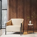 Modern Beige Armchair with Black Metal Frame by Wooden Wall and Side Table with Vase
