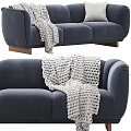 Navy Blue Three Seater Sofa With White Knitted Blanket And Wooden Legs