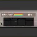 Vintage Commodore 128D Computer With Gray Casing Front Panel Buttons And Colorful Stripe Design