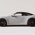 White Porsche Sports Car With Black Alloy Wheels And Sleek Front Design