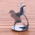 Metal Bird Sculpture with Spread Wings on Metal Base and Wooden Floor