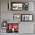 Gray Wall With Decorative Moldings Featuring Various Photo Frames And Artworks
