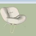 Cream Colored Upholstered Lounge Chair With Curved Backrest And Metal Legs