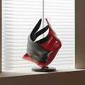 Abstract Red And Black Sculpture With Curved Shapes On Windowsill And Window Blinds Background