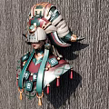 Intricate Sculpture Carving Of Traditional Figure With Ornate Headpiece And Tassel Decorations