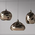 Three Metallic Pendant Lights with Shiny Dome Shapes Hanging in Modern Interior