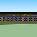 Brown Brick Hotel Building With Multiple Windows Flat Roof And Green Lawn