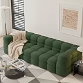 Green Sectional Sofa With Cozy Blanket Glass Coffee Table Floor Lamp And Wall Artwork