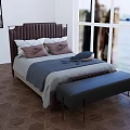 Double Bed With Brown Headboard Pillows Gray Blanket And Navy Bench On Herringbone Wooden Floor