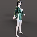 Woman in Green Silk Robe with White Lingerie Standing Barefoot on Gray Background