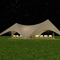 Canopy Tent Under Starry Night Sky On Green Grass Field Illuminated With Seating Area