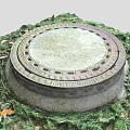 Circular Manhole Cover With Metal Frame In Outdoor Grass And Fallen Leaves Scene