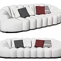 White Plush Sectional Sofa with Curved Rounded Design and Black White Brown Throw Pillows