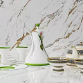 Elegant White Tableware Set With Green Trim And Floral Patterns On Marble Surface