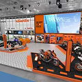 Segway Exhibition Booth In Indoor Hall With Large Screens And Displayed Vehicles