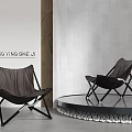 Two Black Leather Lounge Chairs With Metal Frames On Stylish Platform And Pebbles