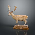 Spotted Deer Taxidermy With Large Antlers On Stone Base Against Dark Background