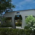Chinese Style Entrance Gate With Gray Walls Arched Doorway And Surrounding Green Plants