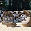 Wicker Outdoor Sofa With Curved Design And Round Coffee Table In Natural Setting