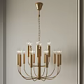 Modern Elegant Golden Chandelier with Multiple Arms and Clear Bulbs in Interior with Light-Colored Wall