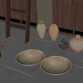 Ceramic Vases And Bowls With Natural Texture On Tile Floor Near Wooden Cabinet
