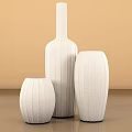 Elegant White Vases with Intricate Carved Patterns and Various Shapes on Beige Background