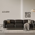 Black Leather Three Seater Sofa With Accent Pillows Striped Throw Blanket Floor Lamp And Wall Art