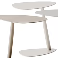 Three Modern Light Toned Side Tables With Slim Legs And Minimalist Design