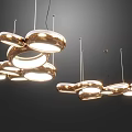 Modern Artistic Chandelier With Multiple Shiny Metal Rings And Warm Glowing Light
