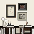 Framed Abstract Paintings Displayed on Wall with Decorative Books Lamps and Sculpture