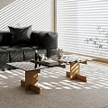 Glass Coffee Table With Wooden Legs On Rug Near Black Leather Sofa And Sunlight Patterns
