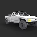 White Pickup Truck With Large Off Road Tires And Modified Front Bumper
